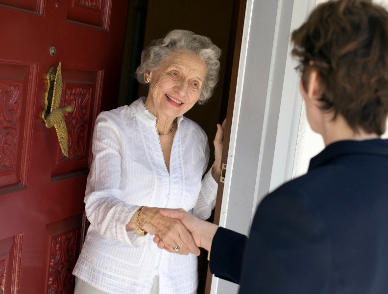 Image of a lady answering the door